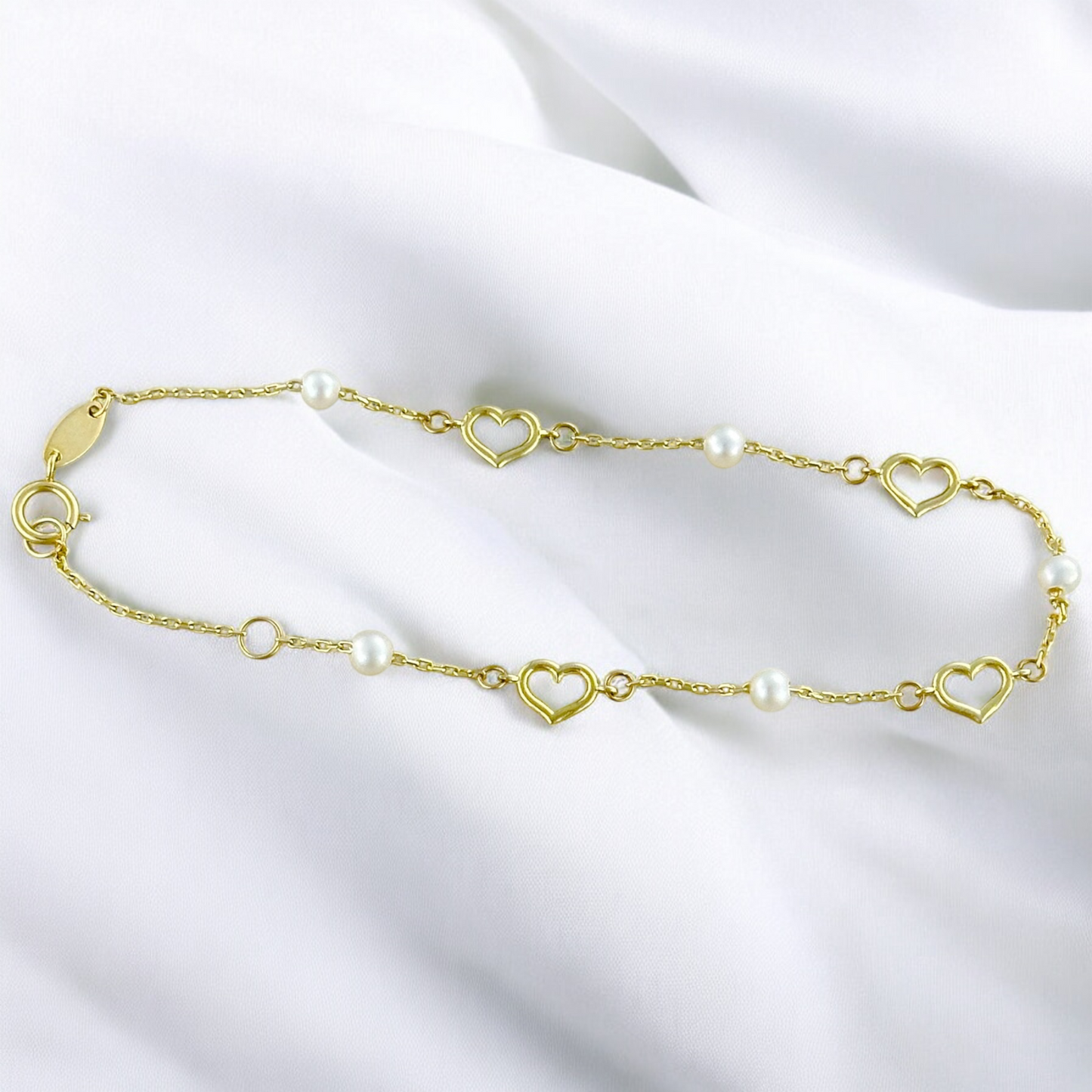 PULSERA CORAZONES PERLAS ORO 10K